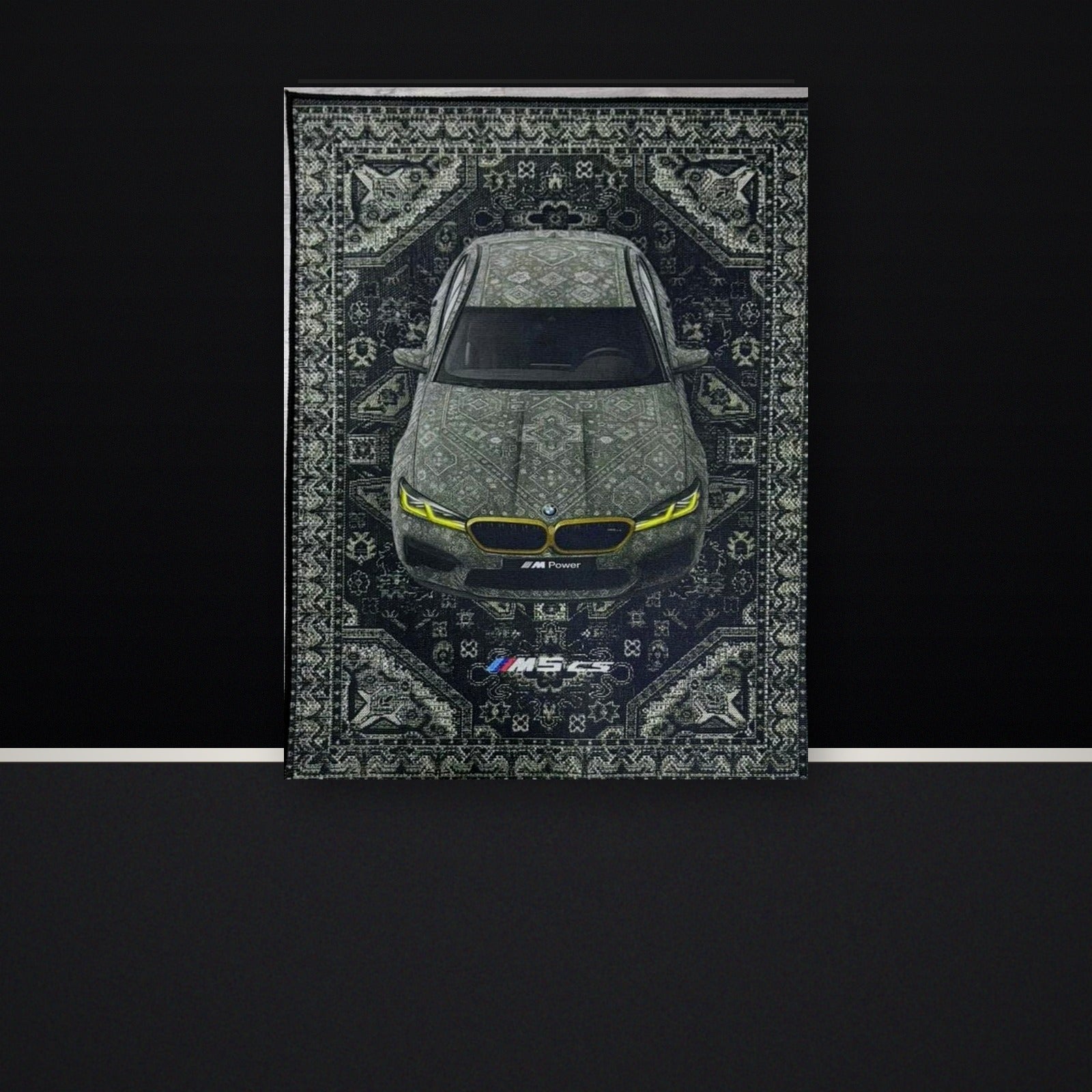 BMW M5 CS wall tapestry displayed against a black showroom-style wall