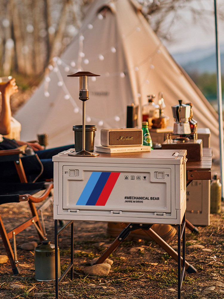 BMW foldable trunk storage box on campsite table with M tri-color stripe