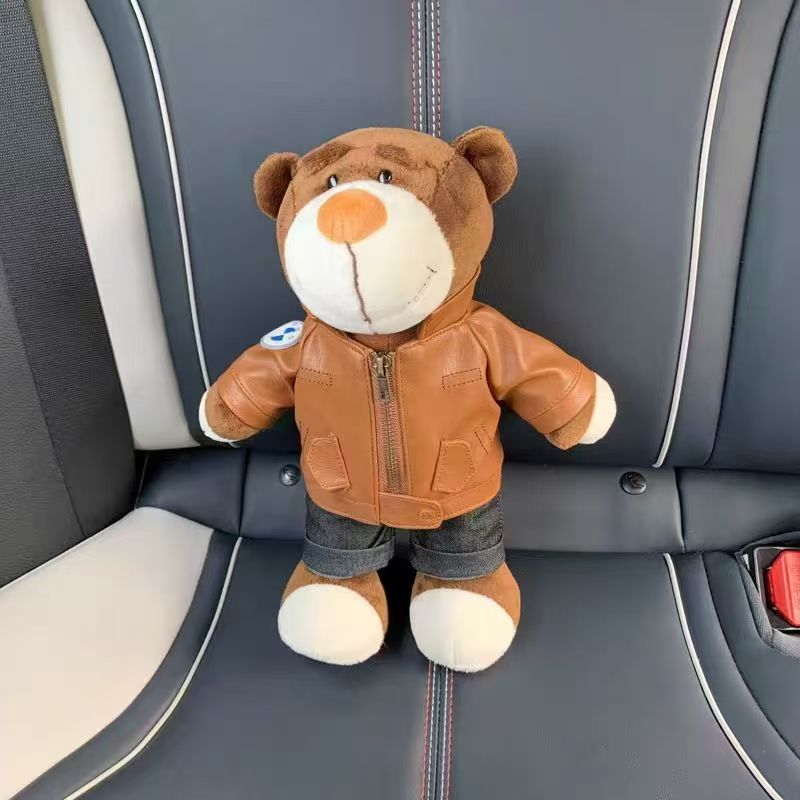 BMW bear doll in white and red racing suit in car seat