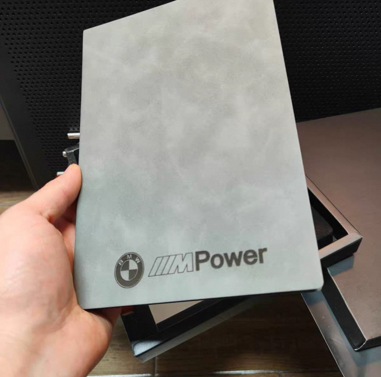BMW M Power notebook cover held in hand, front view