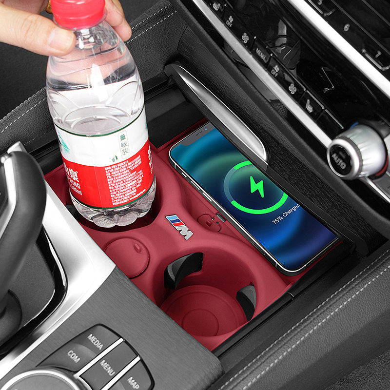 BMW cup mat with water bottle and wireless charging phone in console