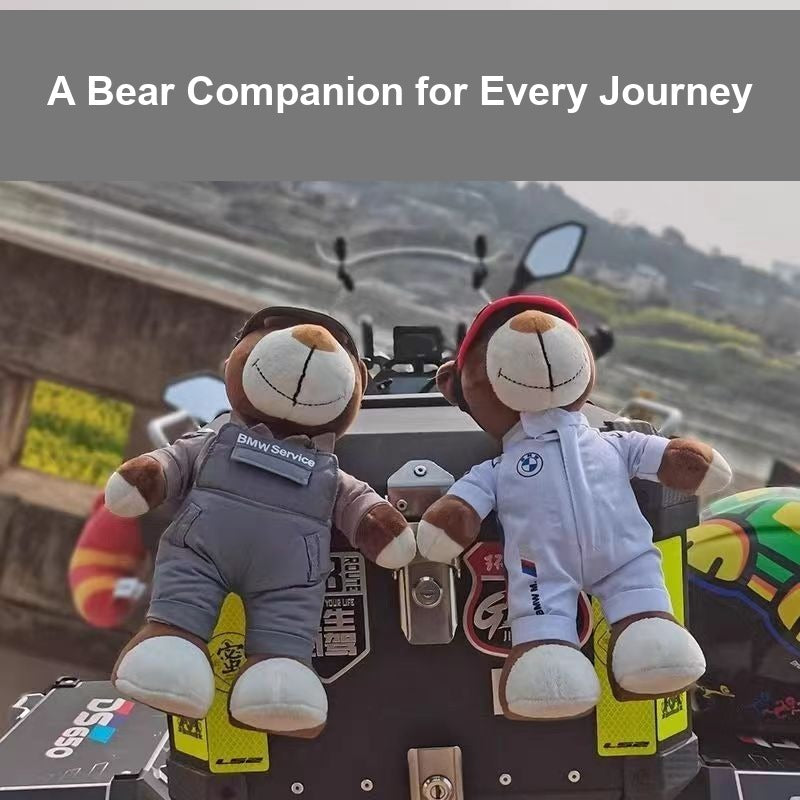 Two BMW technician bear dolls attached to motorcycle luggage rack