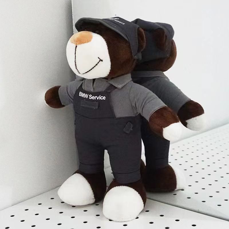 Two BMW M Performance bear dolls in black racing suits