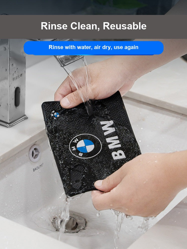 Washing BMW anti-slip mat under running water to clean