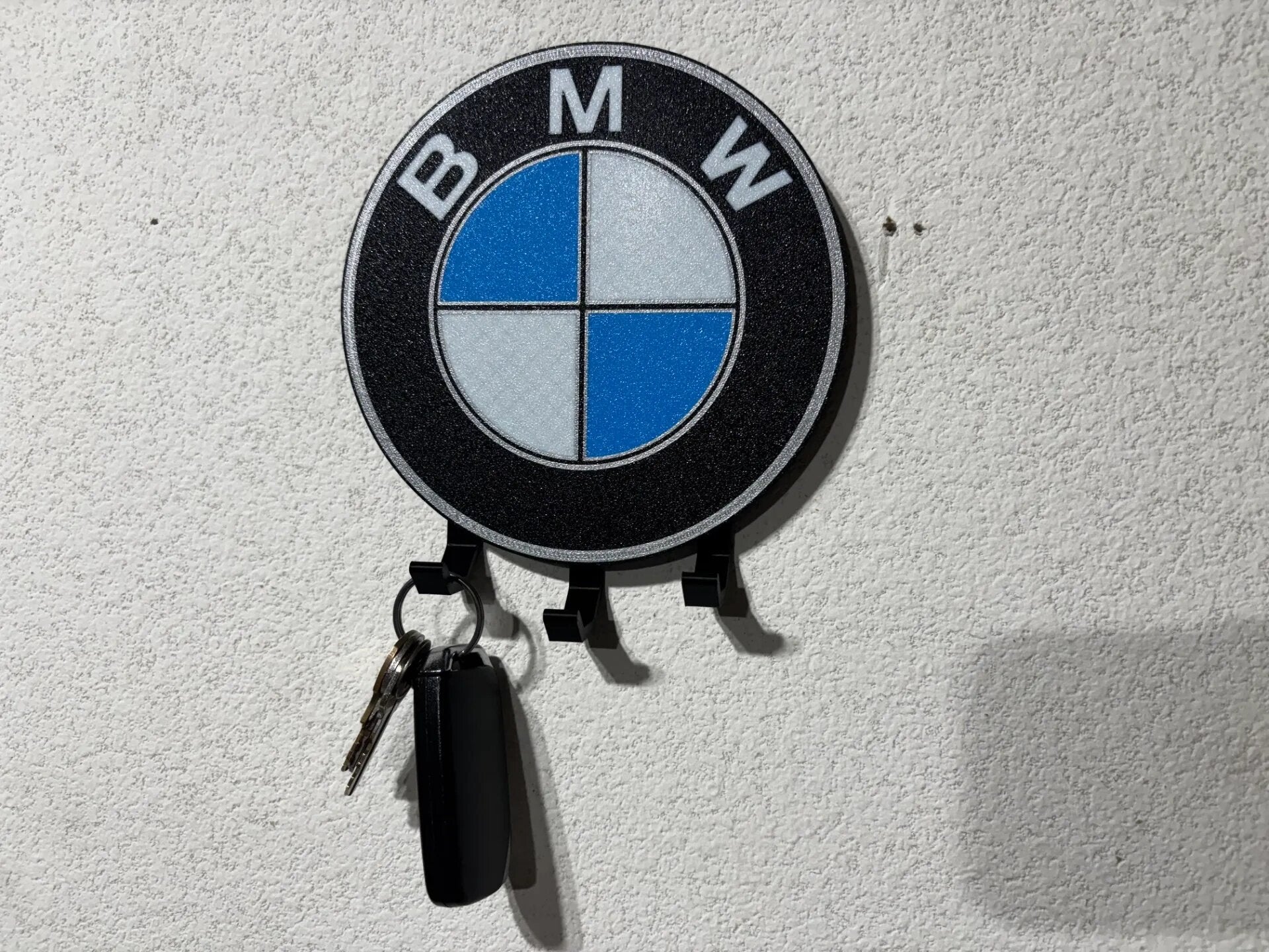 BMW roundel badge 3D wall key hook mounted on textured wall