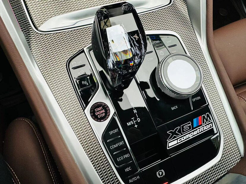 BMW X6M Competition center console badge sticker installed in car interior