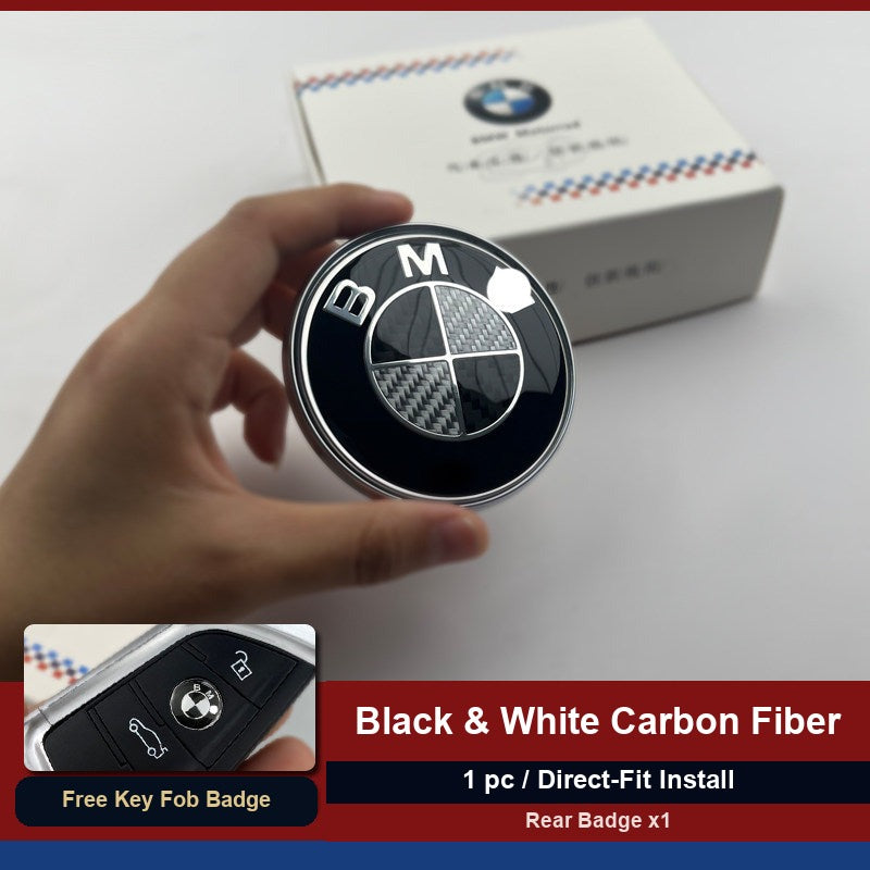 BMW carbon fiber rear trunk badge held in hand with packaging box