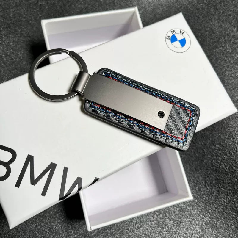 BMW M keychain metal plate close-up on gift box