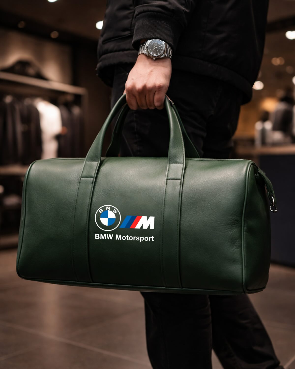 Man carrying BMW Motorsport green leather duffel bag