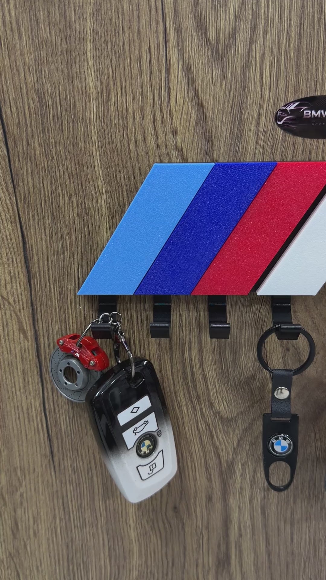 BMW M Stripe wall key holder product video - showing the key rack in use with BMW keychains